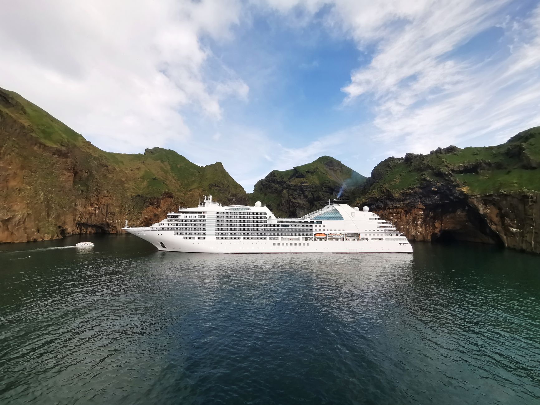 cruise ship in a scenic rocky cove