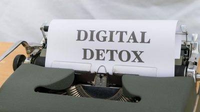 a typewriter with a paper that says digital detox