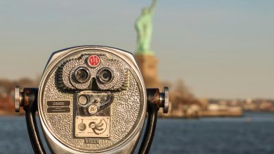 lens in front of statue of freedom