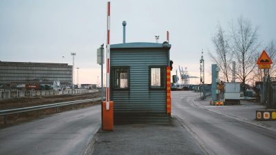 a barrier at the entrance to an industrial area