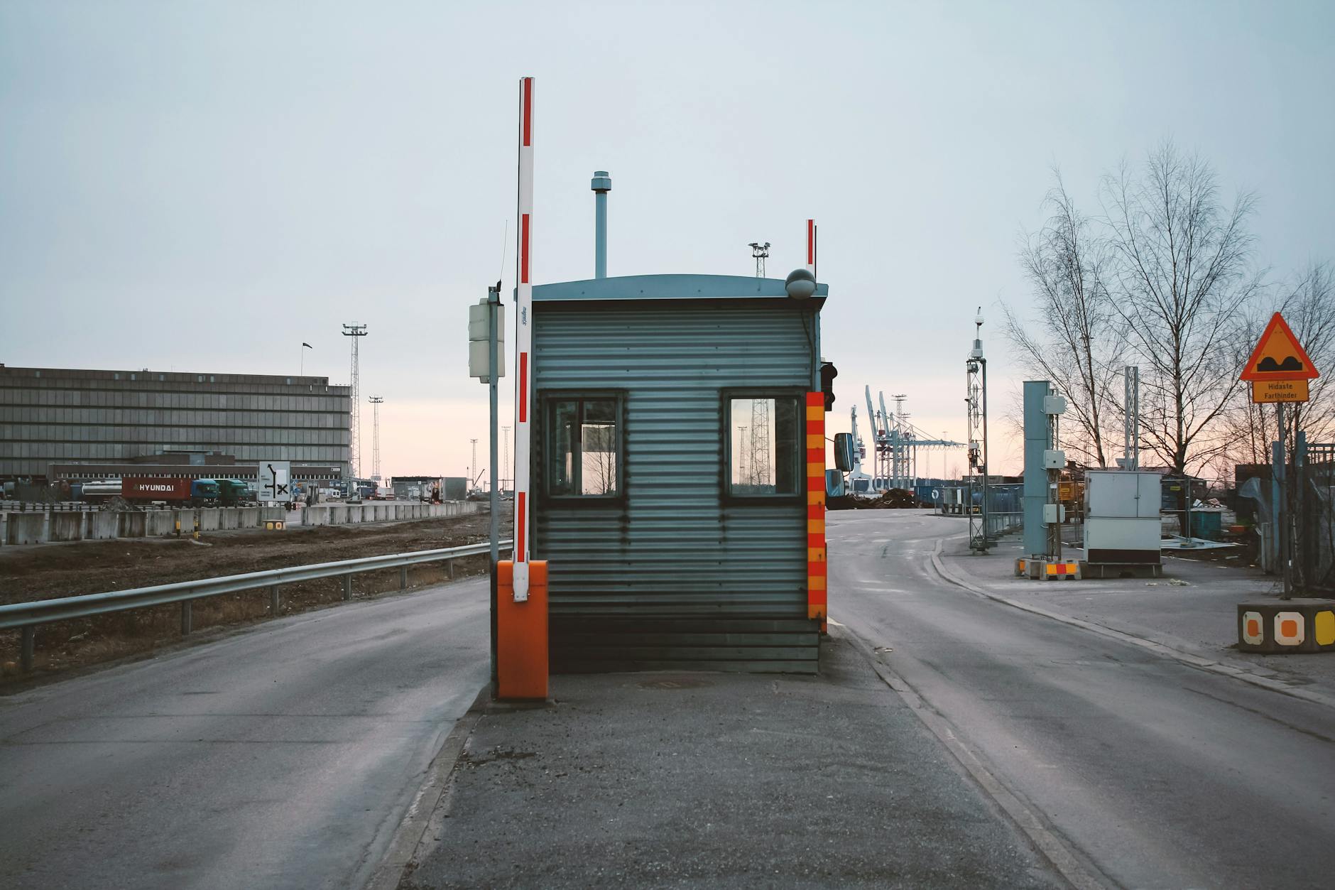 a barrier at the entrance to an industrial area