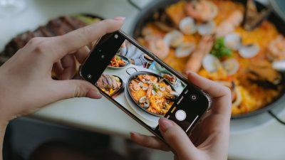 woman taking a picture of a dinner