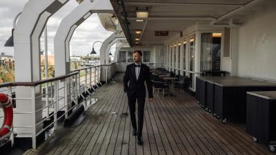 elegant man in tuxedo on ship