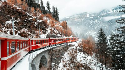 red train in a mountain valley