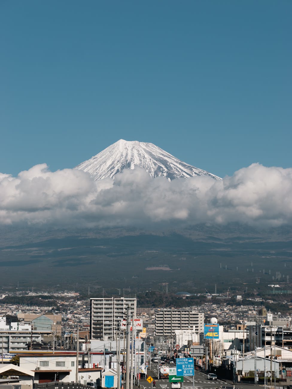 city of shizuoka with mount fuji shrouded in clouds in the background