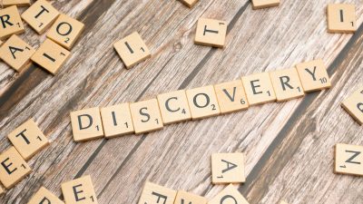 the word discovery spelled out in scrabble letters