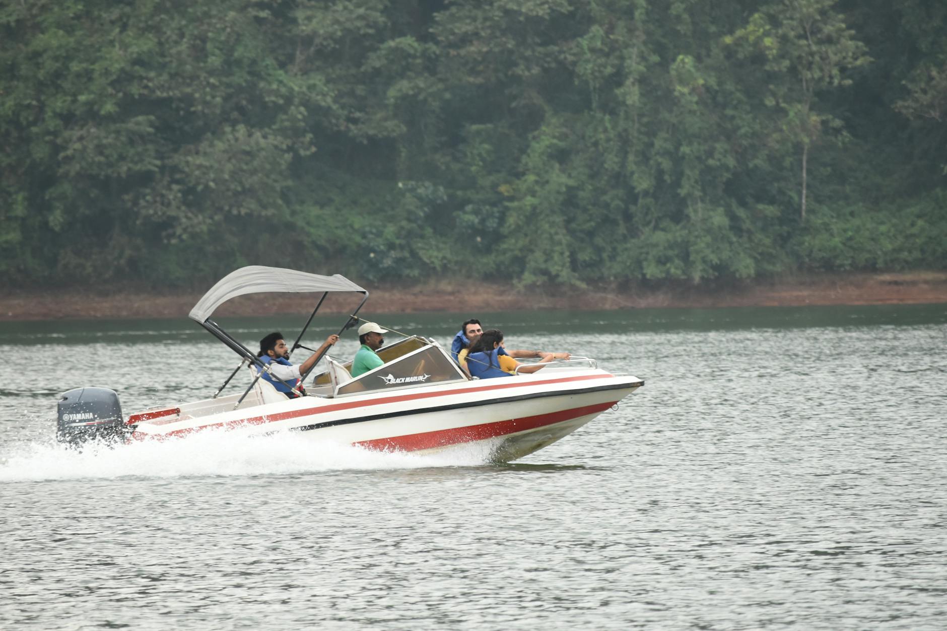 people riding a motorboat on a body of water