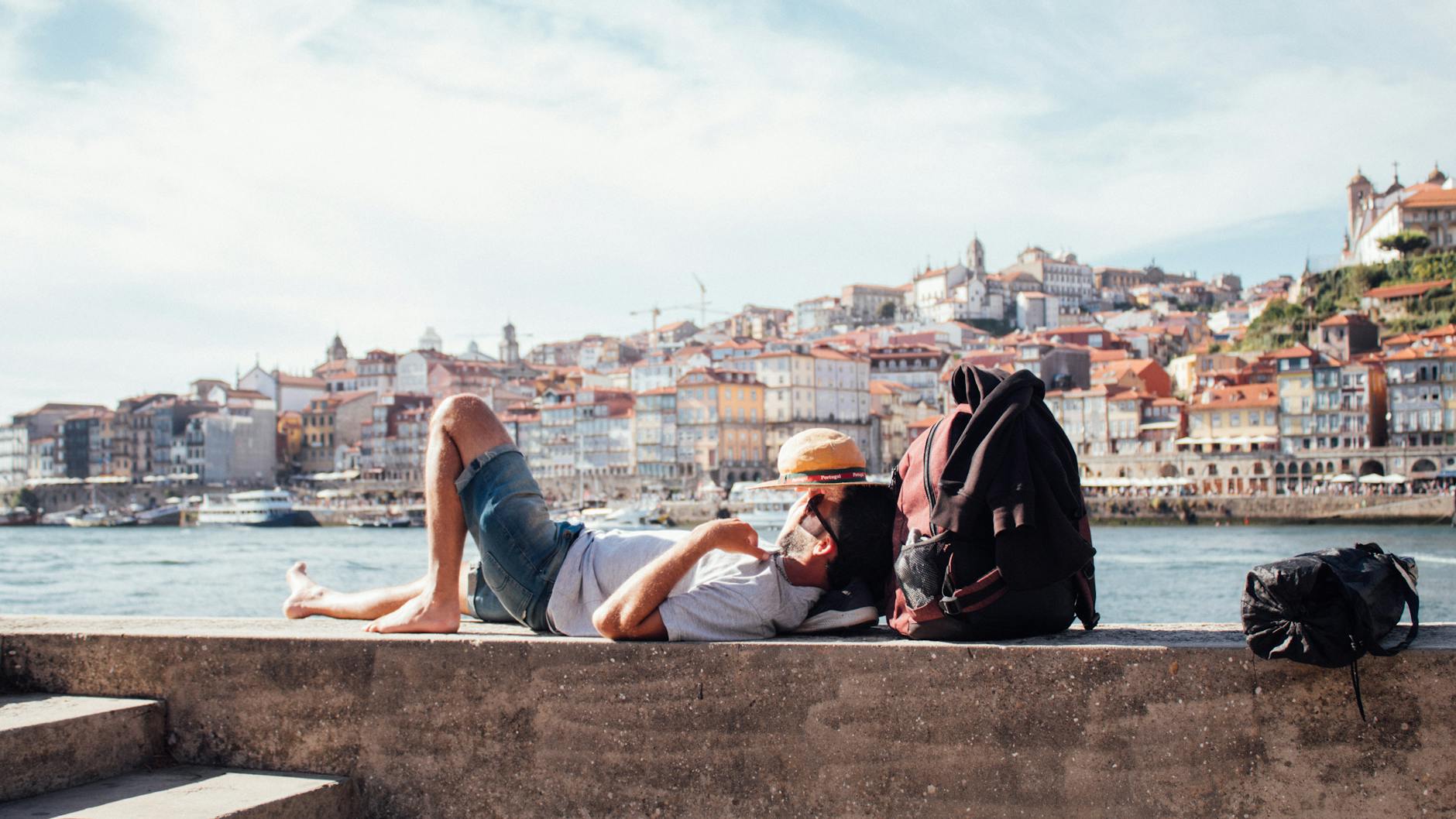 man lying in port in porto