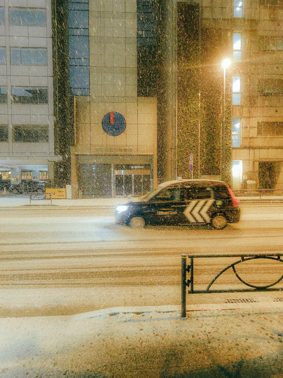 taxi on snowy street in city