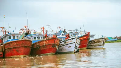 red and white weathered boats moored at a coast