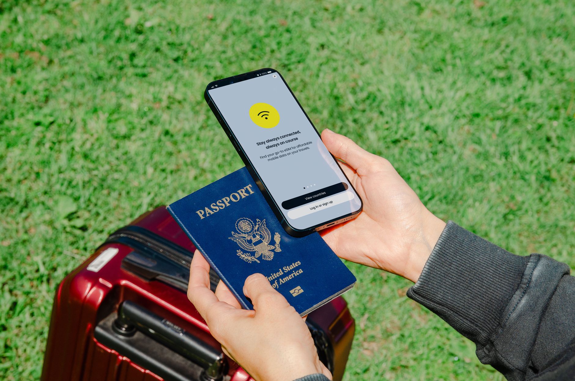 close up of a person holding a passport and a smartphone