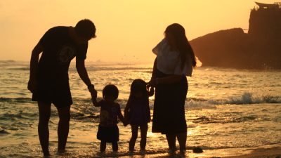silhouettes of a family at the beach
