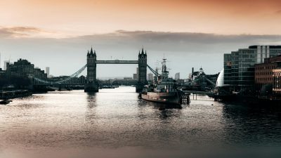 black boat beside bridge