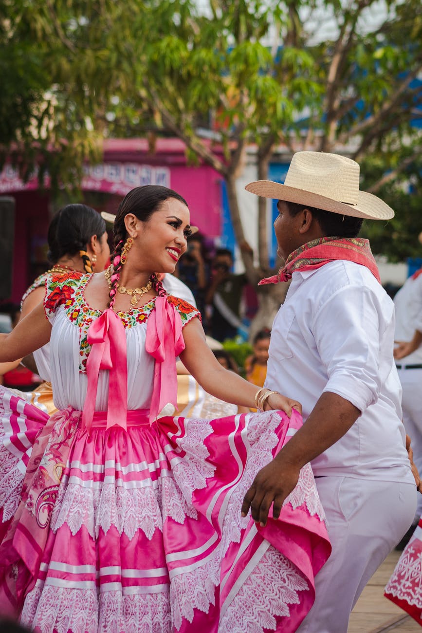 people wearing traditional mexican clothing dancing together