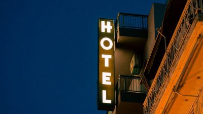 illuminated hotel sign on the side of a building