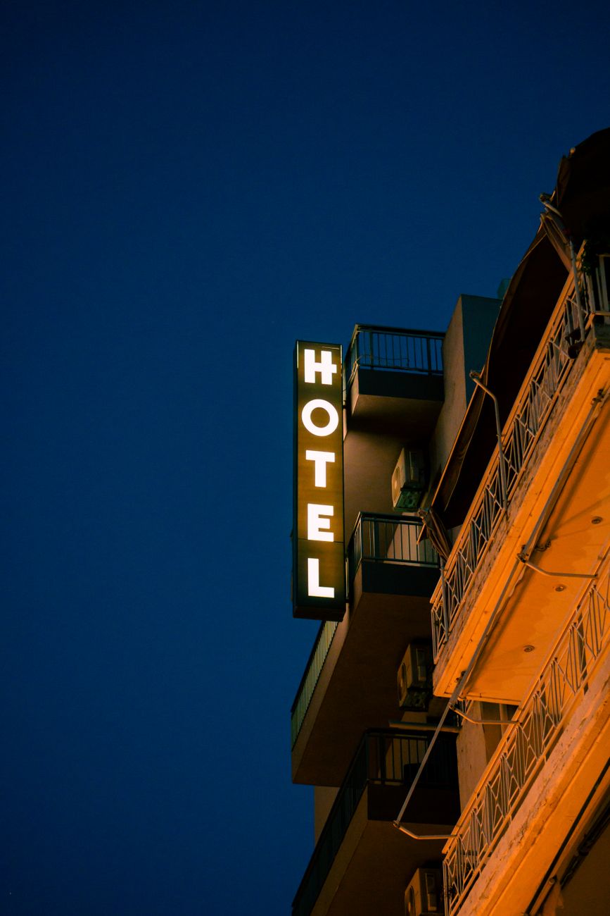 illuminated hotel sign on the side of a building