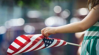 girl holding a flag of usa