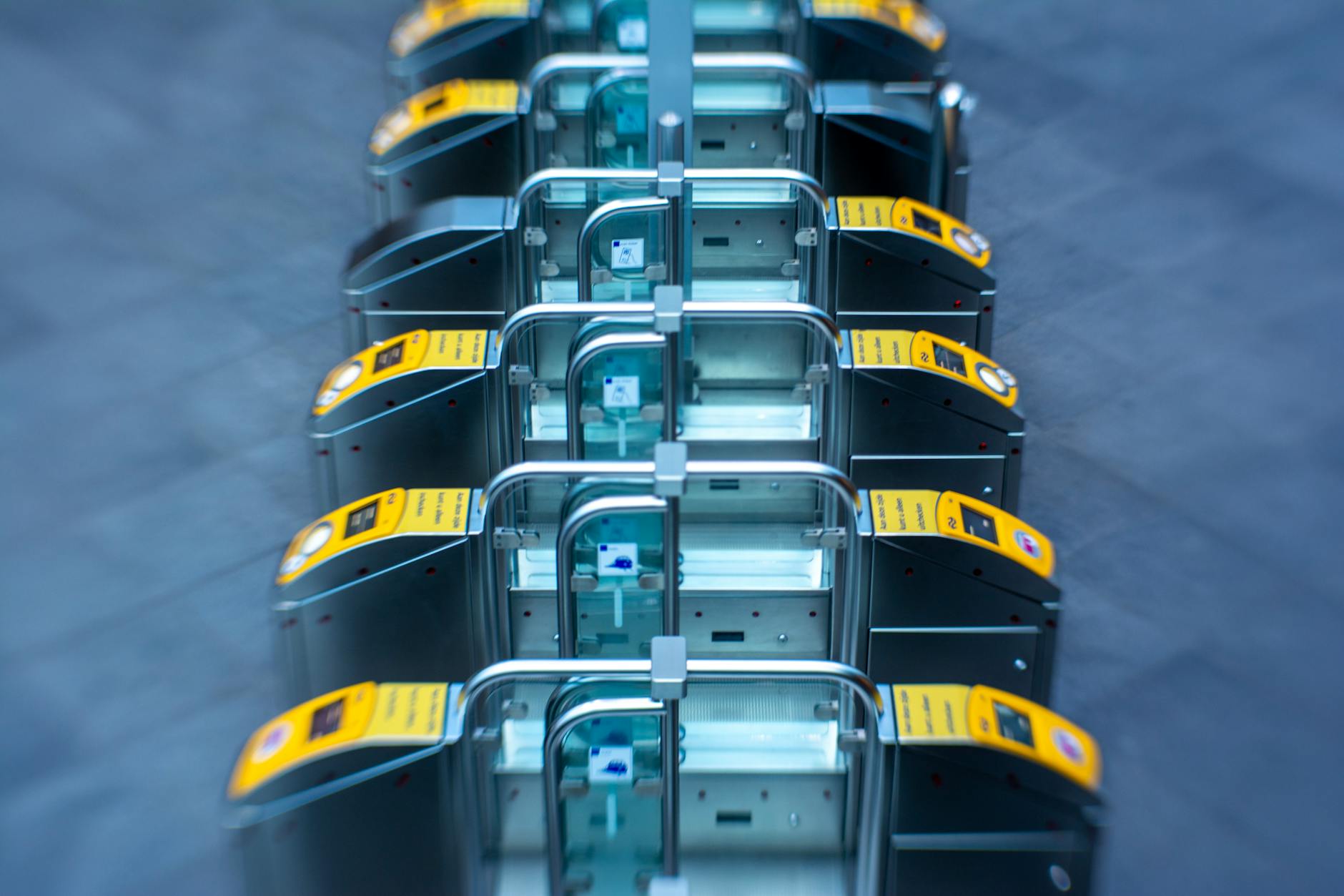 a row of yellow and black ticket machines