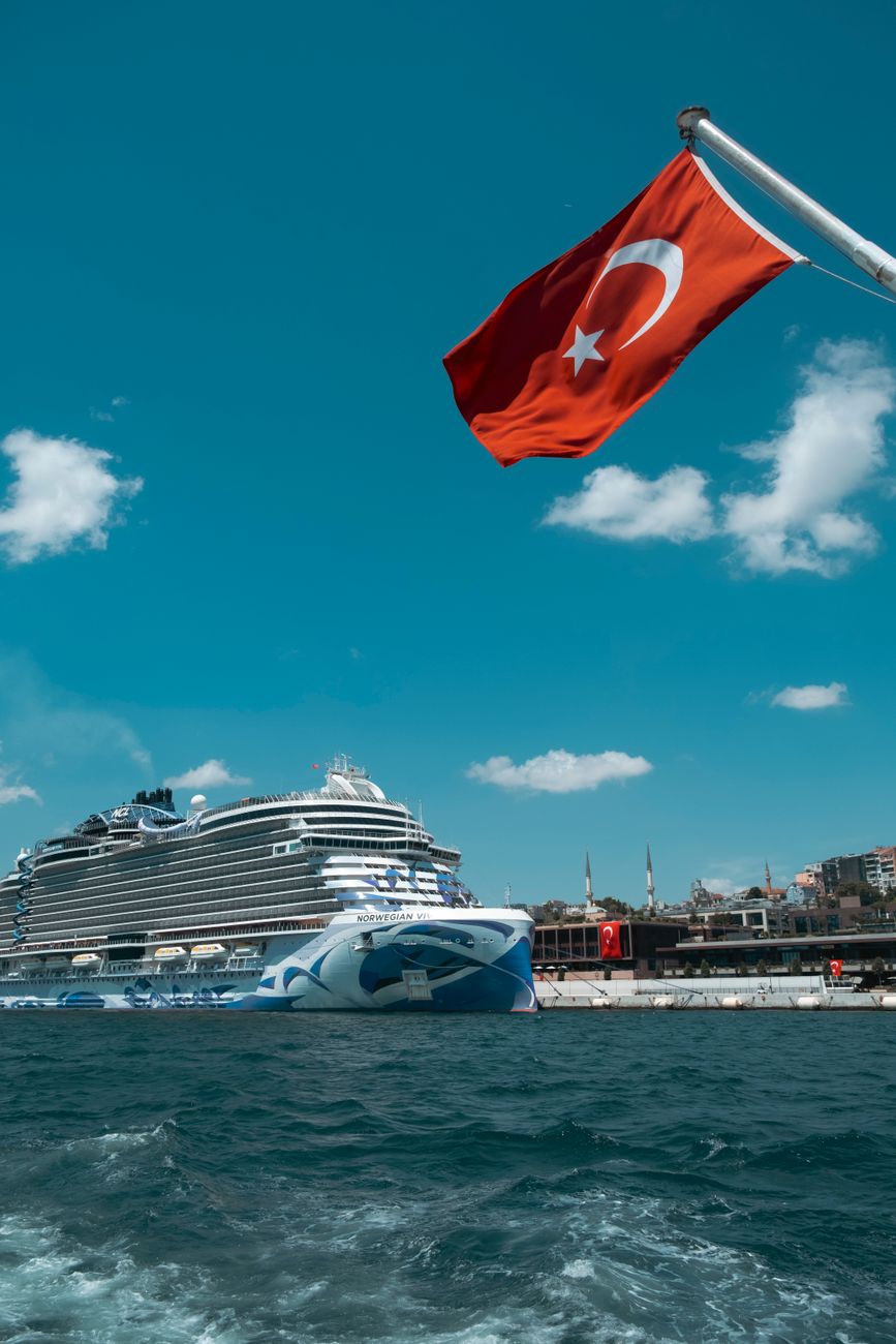 a cruise ship with a turkish flag in the water