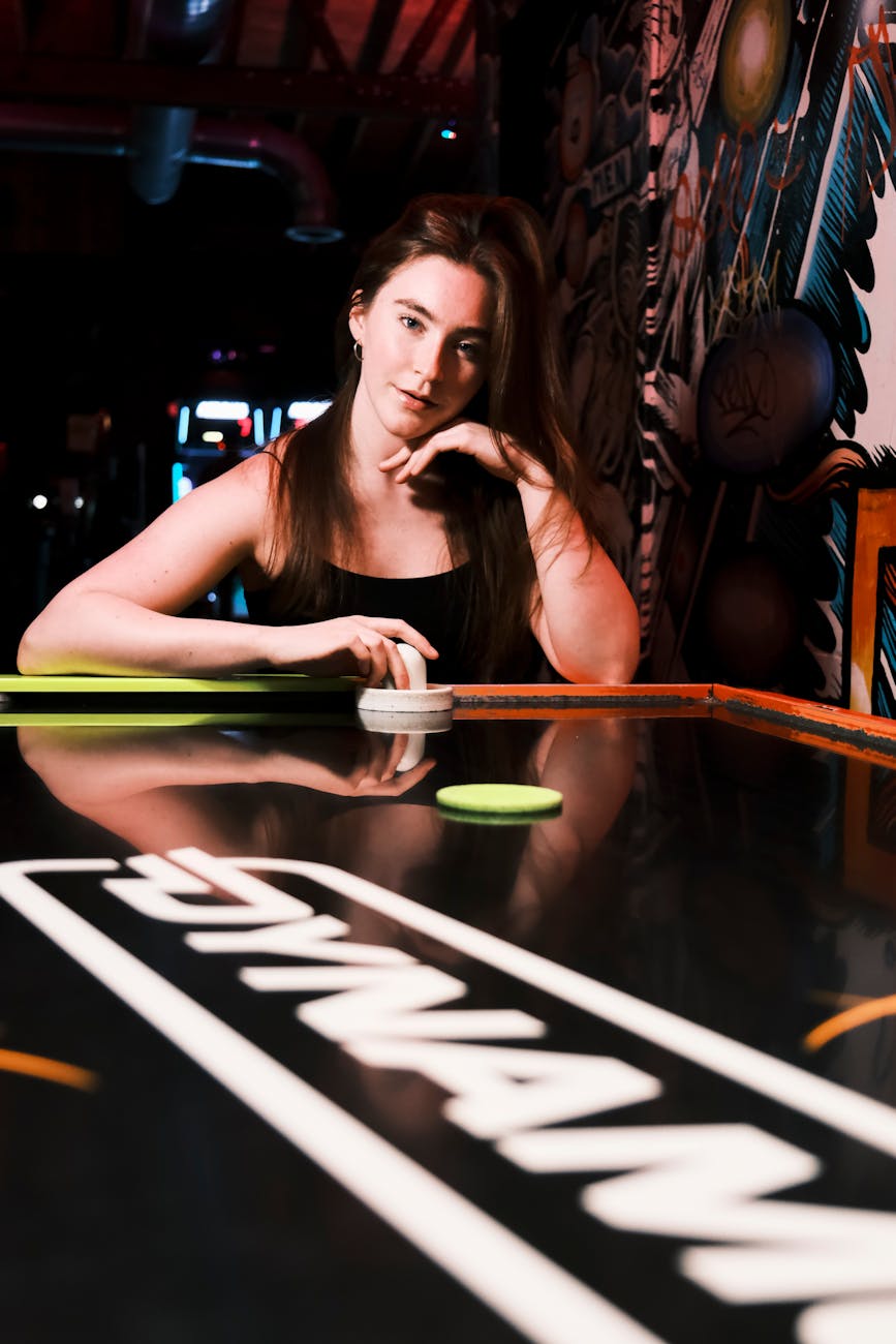 a woman sitting on top of a table with a black table