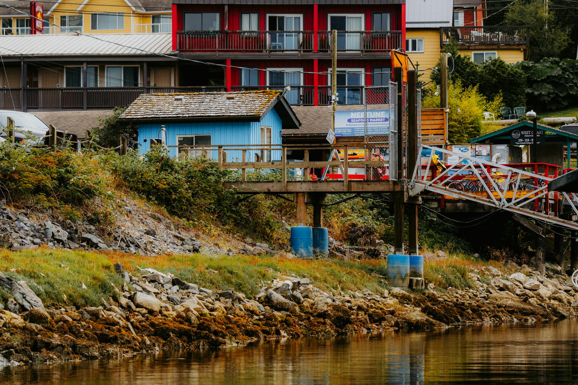 a house is on a dock next to a body of water