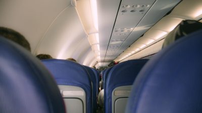 the inside of an airplane with passengers sitting in seats