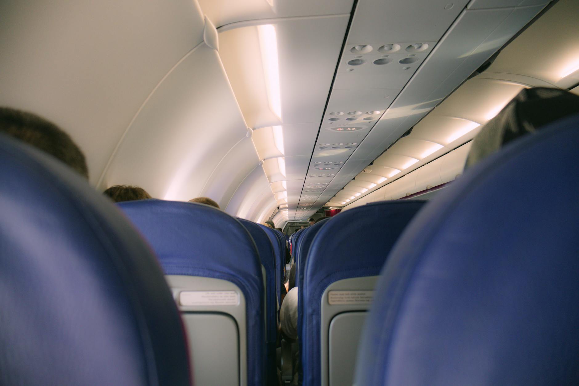 the inside of an airplane with passengers sitting in seats