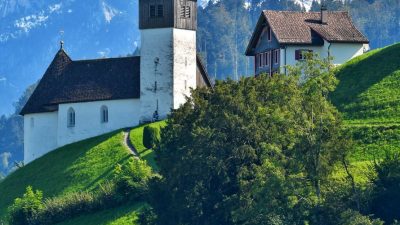 scenic alpine church with snowy mountain background