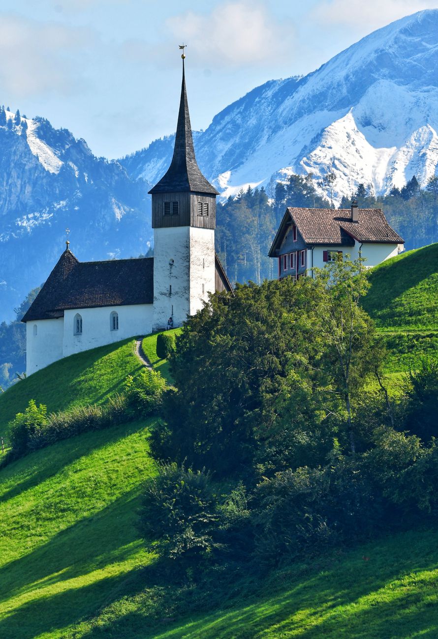 scenic alpine church with snowy mountain background
