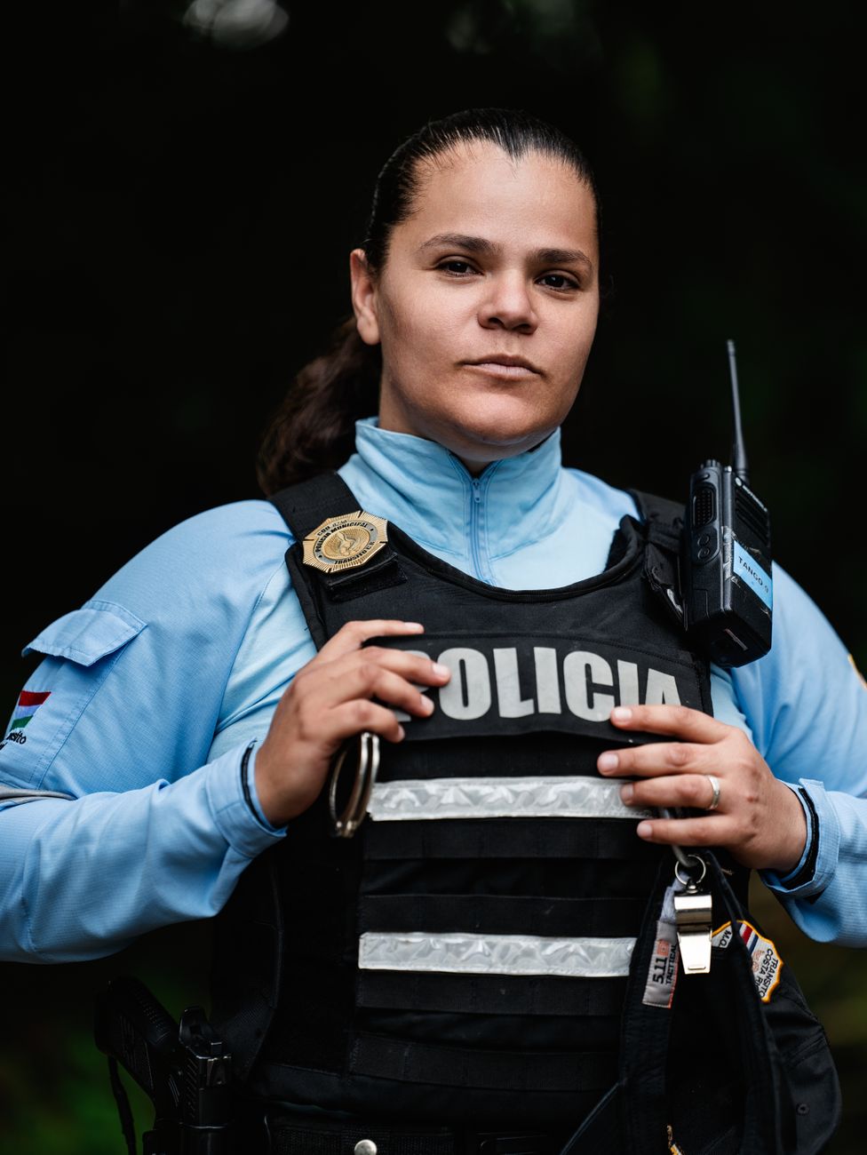 confident female police officer in uniform outdoors