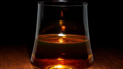 elegant whiskey glass on wooden surface
