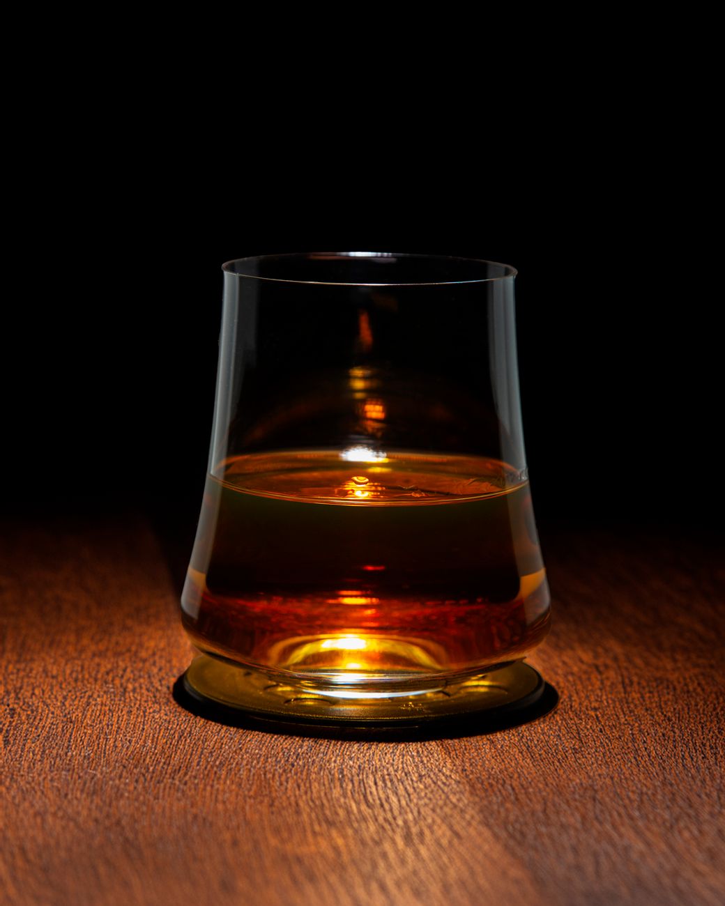 elegant whiskey glass on wooden surface
