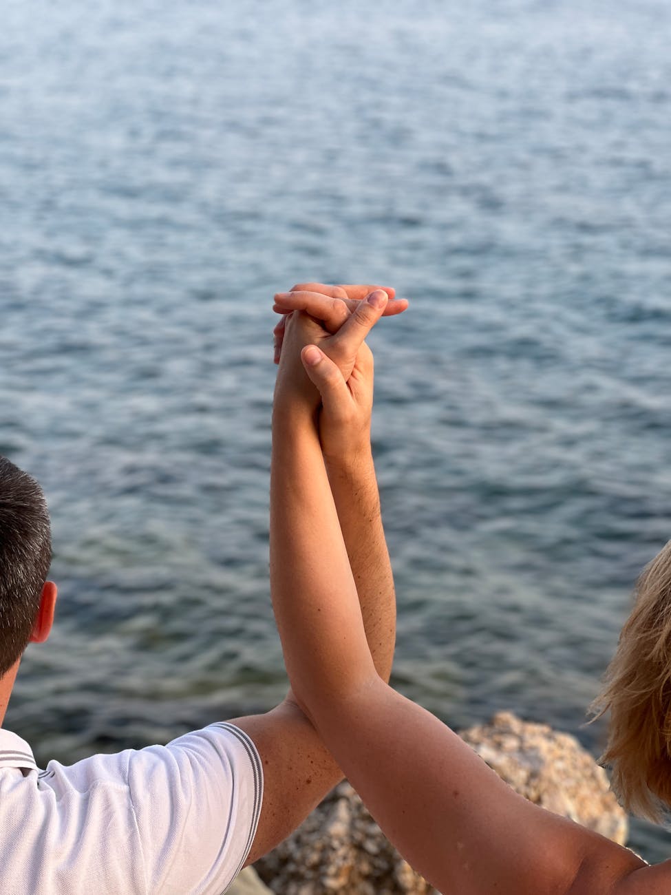 romantic couple holding hands by the adriatic sea