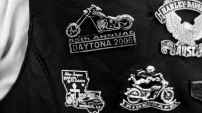 close up of motorcycle club patches on leather vest