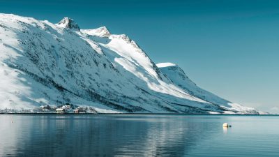 snowy mountains reflecting in arctic waters