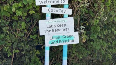 welcome sign at cococay bahamas beach entrance