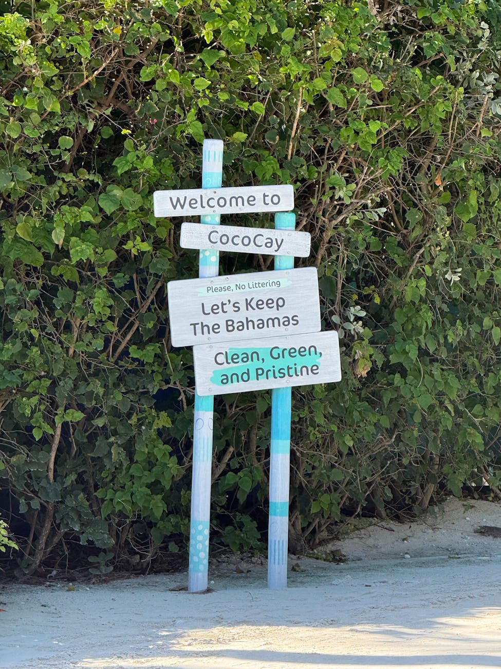 welcome sign at cococay bahamas beach entrance
