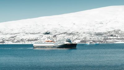 cruise ship sailing in arctic landscape