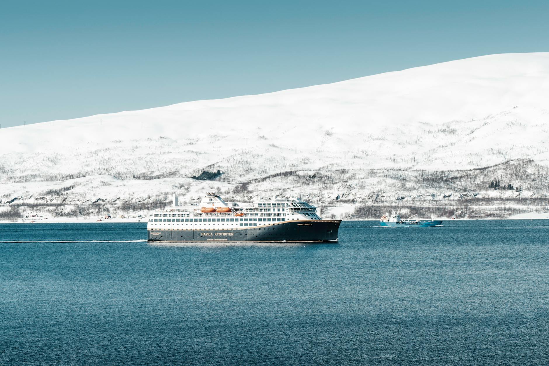 cruise ship sailing in arctic landscape
