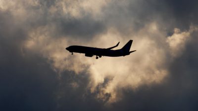 airplane silhouette in dramatic cloudy sky