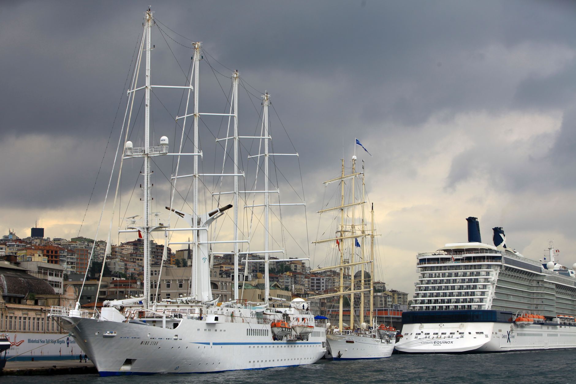 luxury cruise ships docked at urban harbor