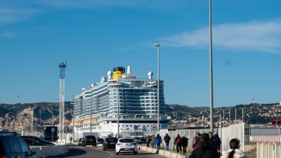 cruise ship docked at port with travelers