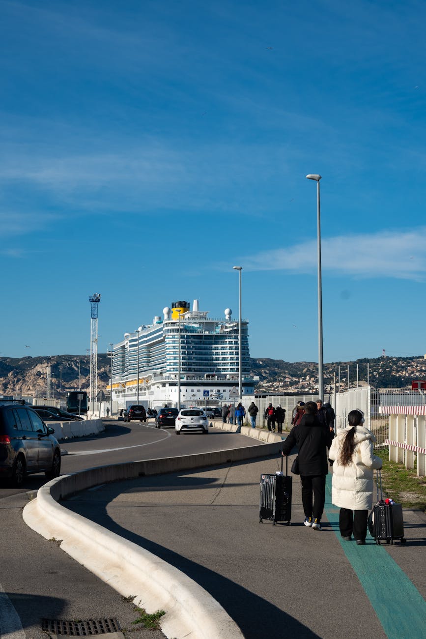 cruise ship docked at port with travelers