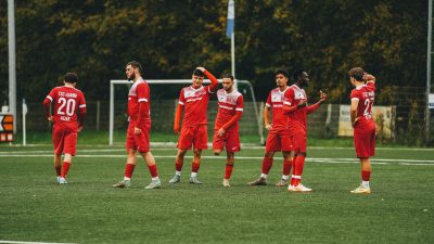 amateur soccer team in red uniforms on field