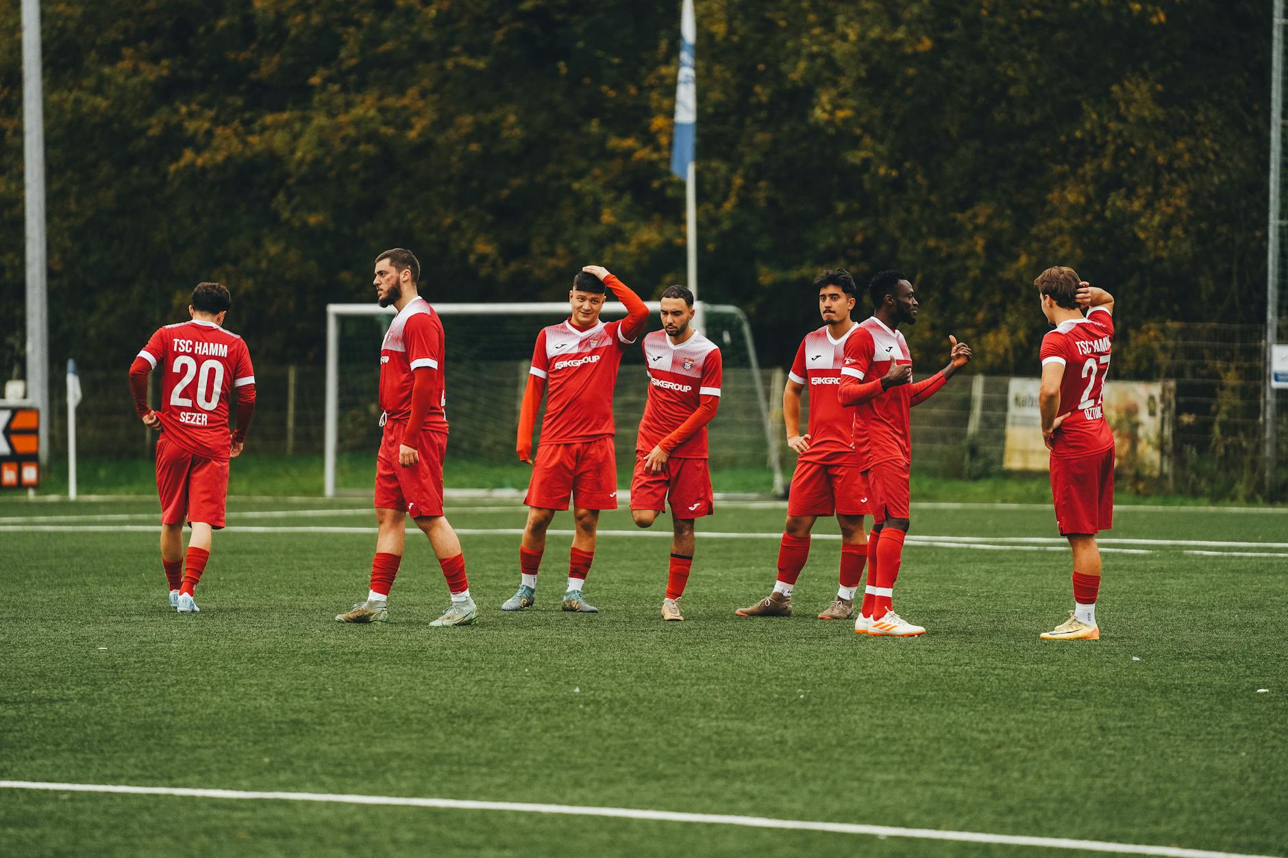 amateur soccer team in red uniforms on field
