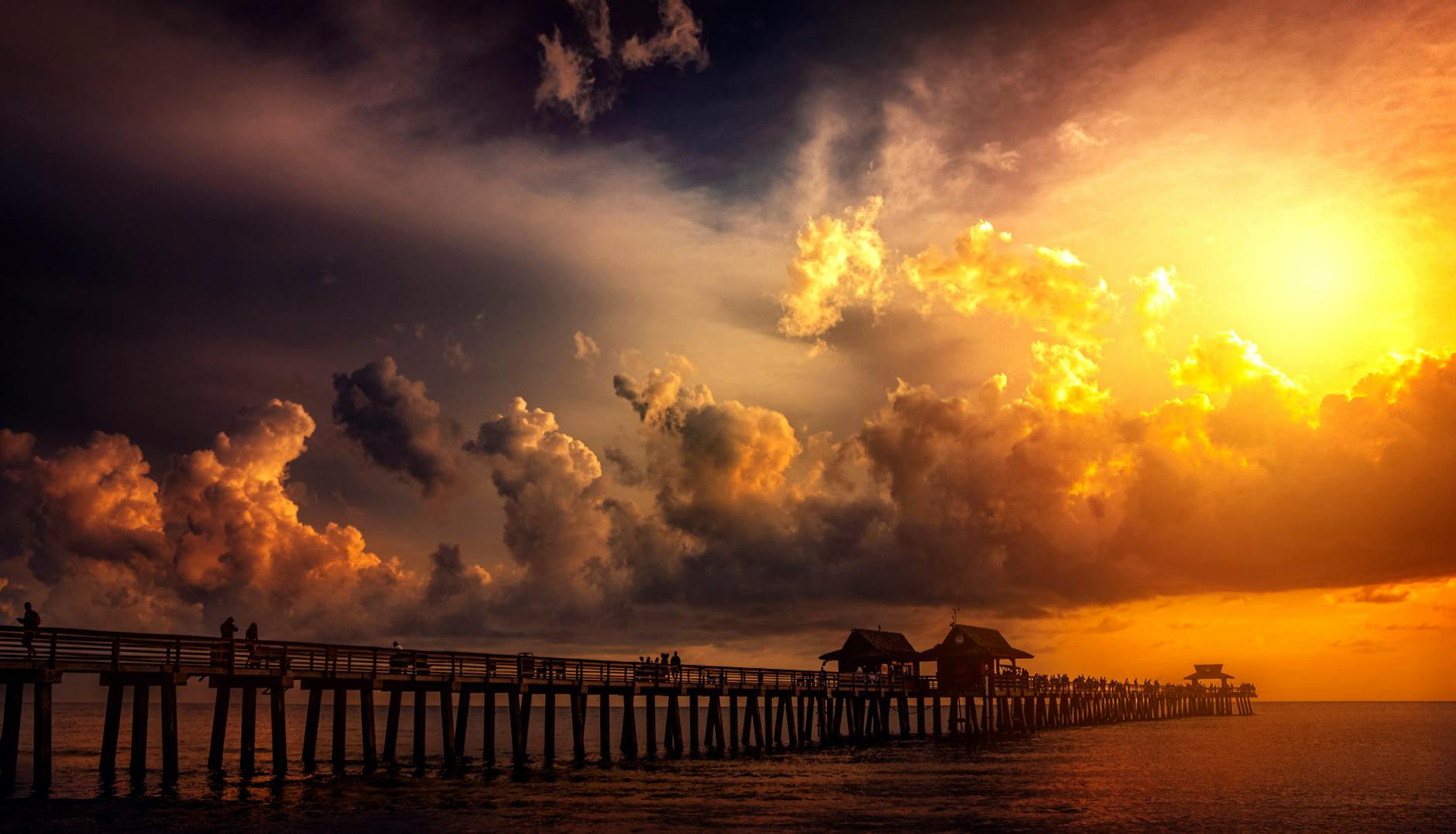 boardwalk in ocean during golden hour