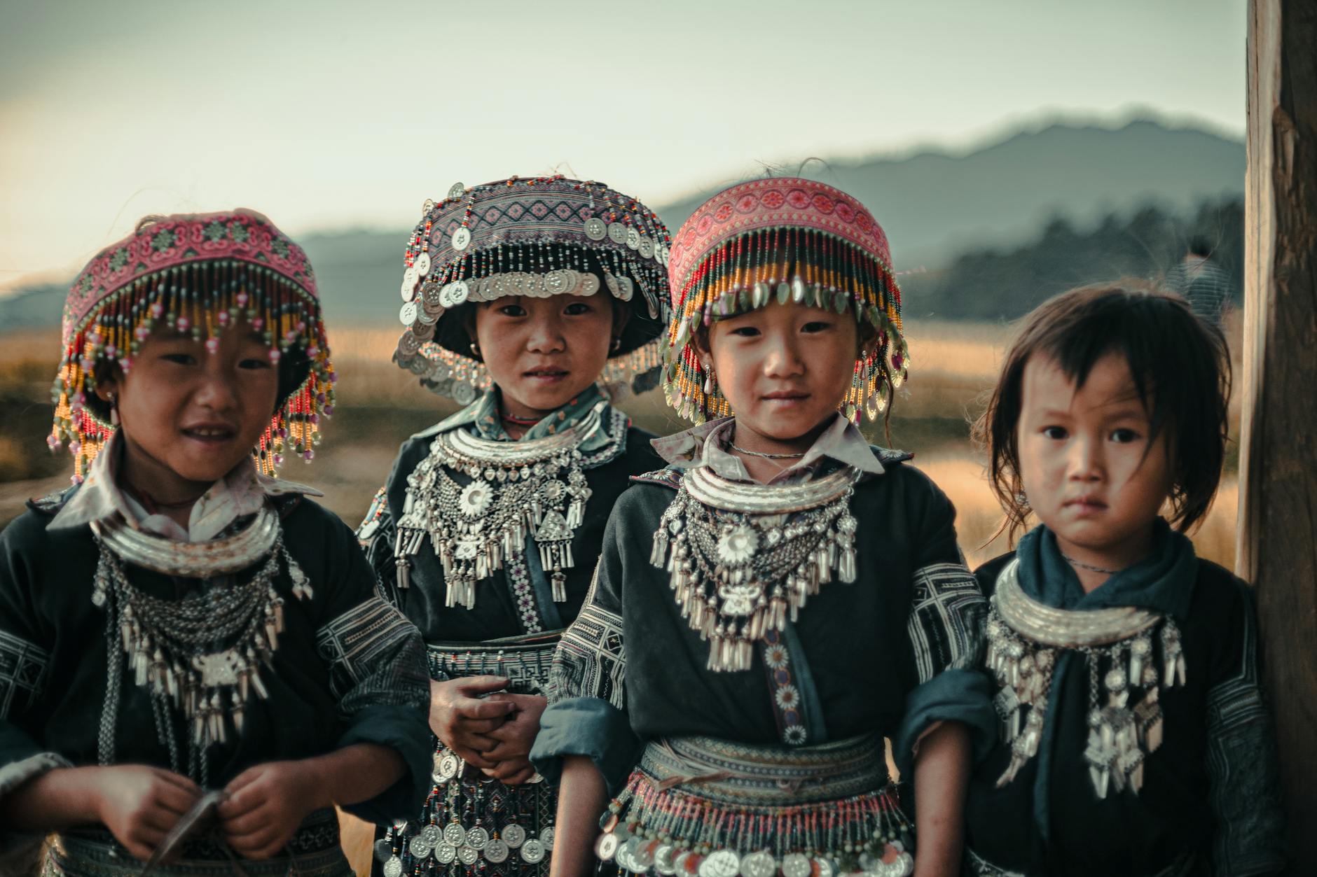 children in traditional tribal attire outdoors