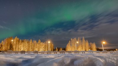 aurora borealis over snowy lapland landscape