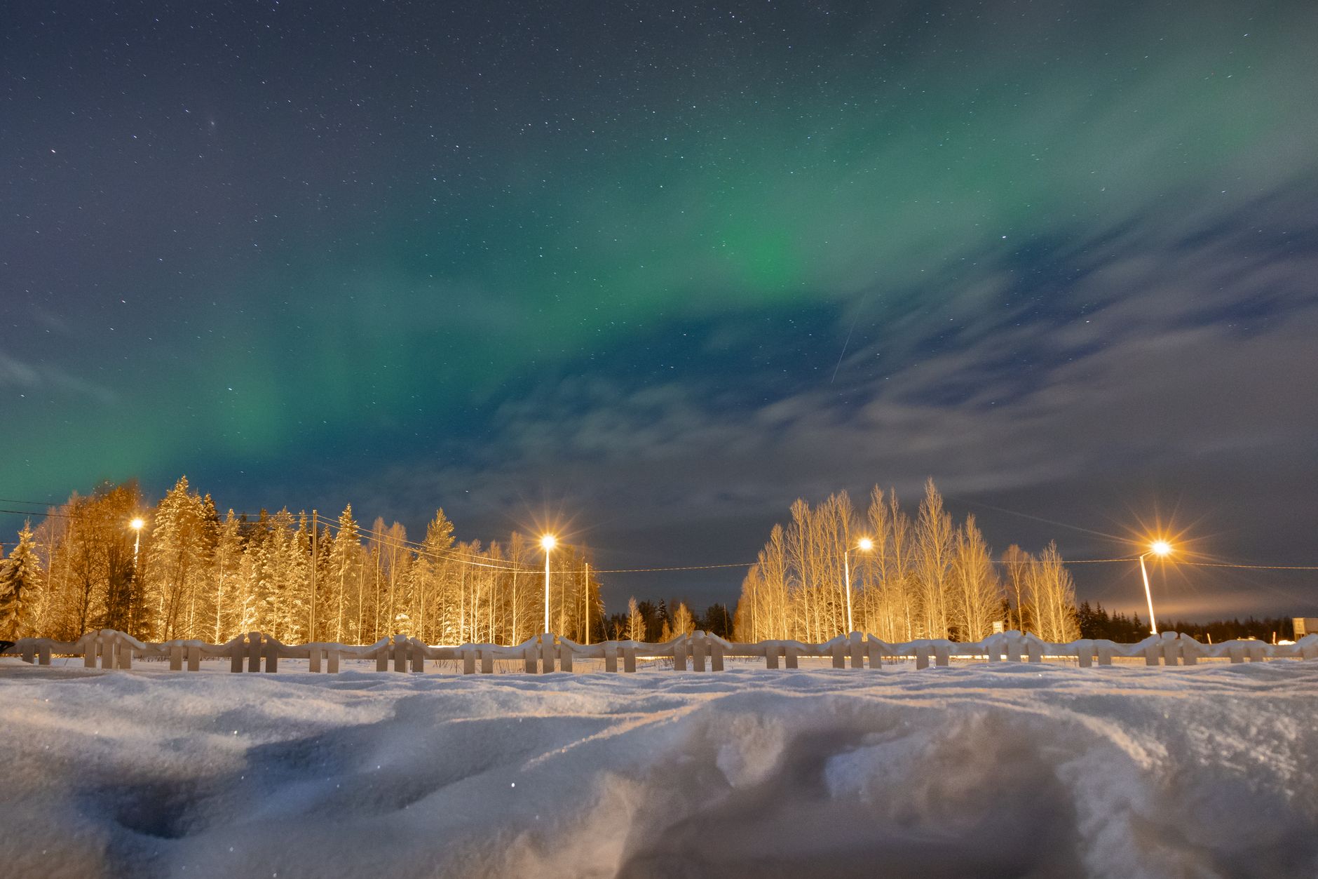 aurora borealis over snowy lapland landscape