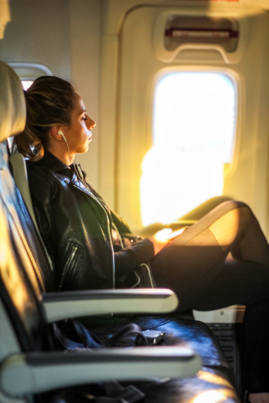 peaceful woman gazing out airplane window